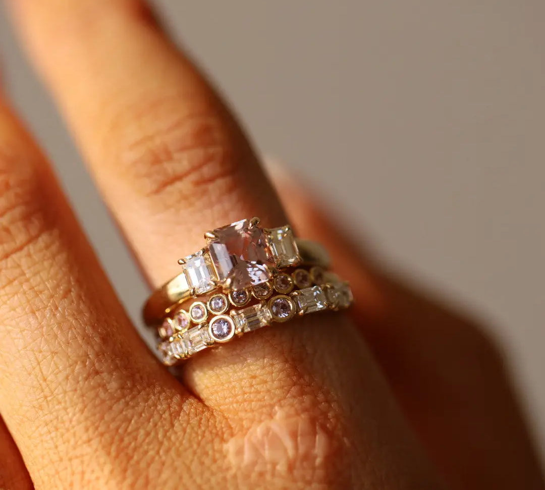 Close up of 1.76ct Pink Sapphire and Diamond Ring with Cosmic Light & Third Band on finger