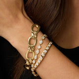 Twist Link Bracelet + Lisse Tennis Bracelet +Little White Diamond Cuff close up on woman's wrist