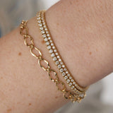 Close up of woman's wrist spotlighting multiple Marrow Fine bracelets
