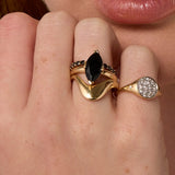 Close up of woman with hands near her face, wearing the Asymmetrical Sculpted Band