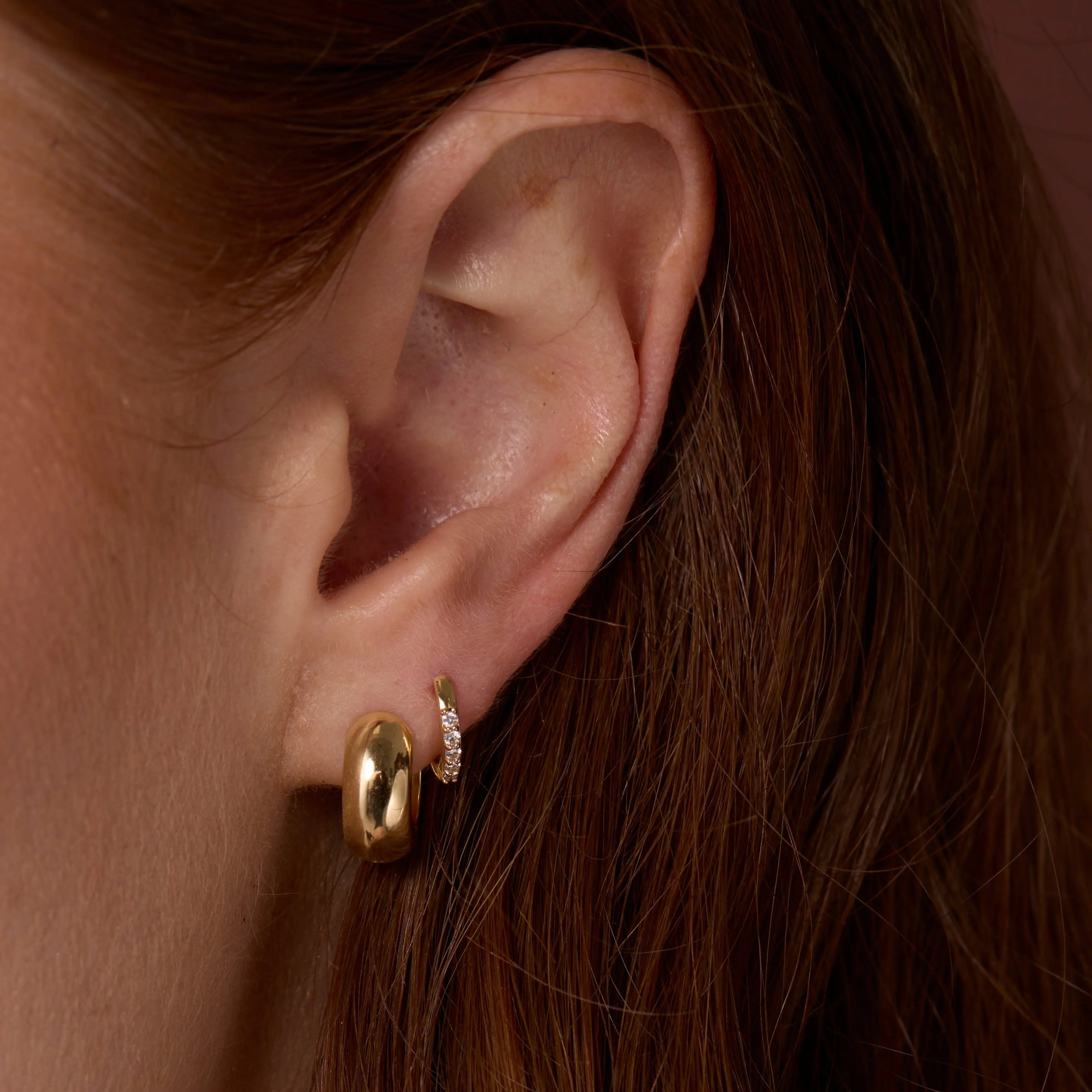 Close up of Mini White Diamond Hoops on ear