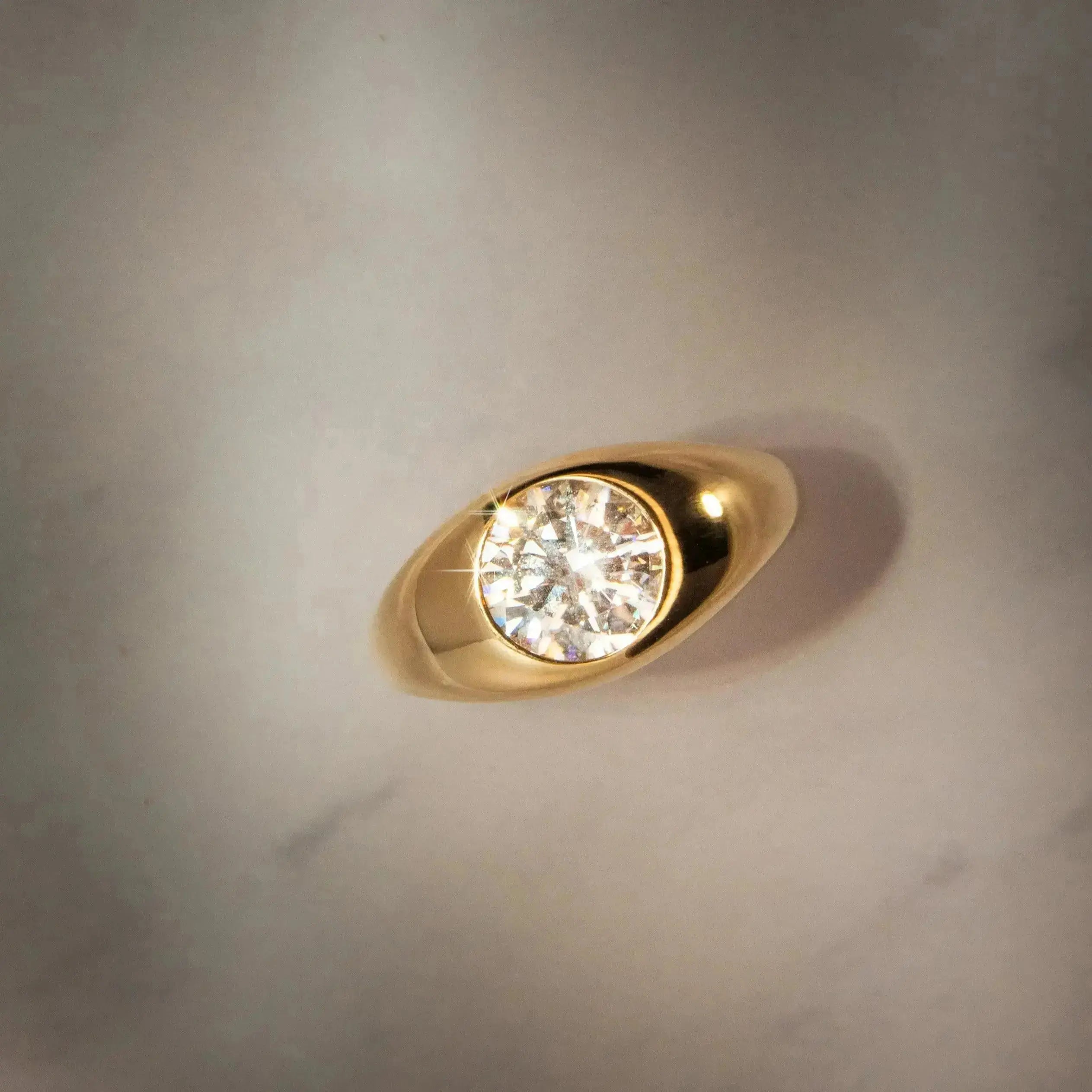 Flat lay birds eye view of Dyllan Round Engagement Ring in yellow gold