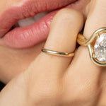 Close up of women's hand featuring multiple Marrow Fine rings styled together