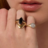 Close up of woman resting hand against her chin, highlighting multiple Marrow Fine rings styled and stacked together