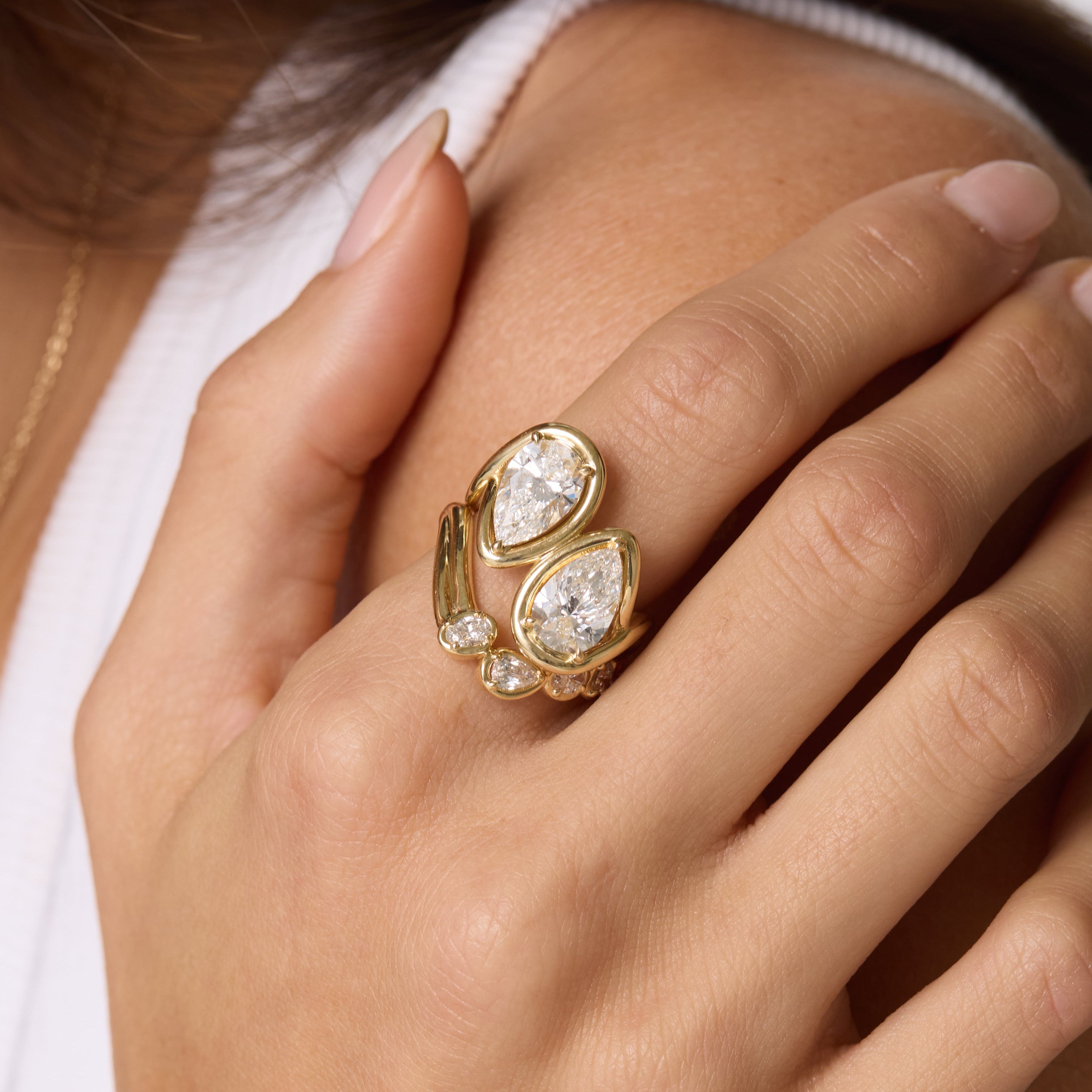 Close up of Joanie Bypass Ring and Simone Arch Band styled on woman's pointer finger