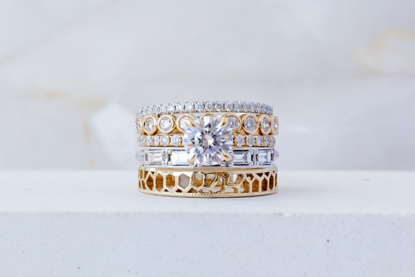 Close up of ring stack featuring rings of different gold colors