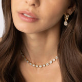 Close up of woman waring Odette Oval Drop Earrings and Lisse Tennis Necklace