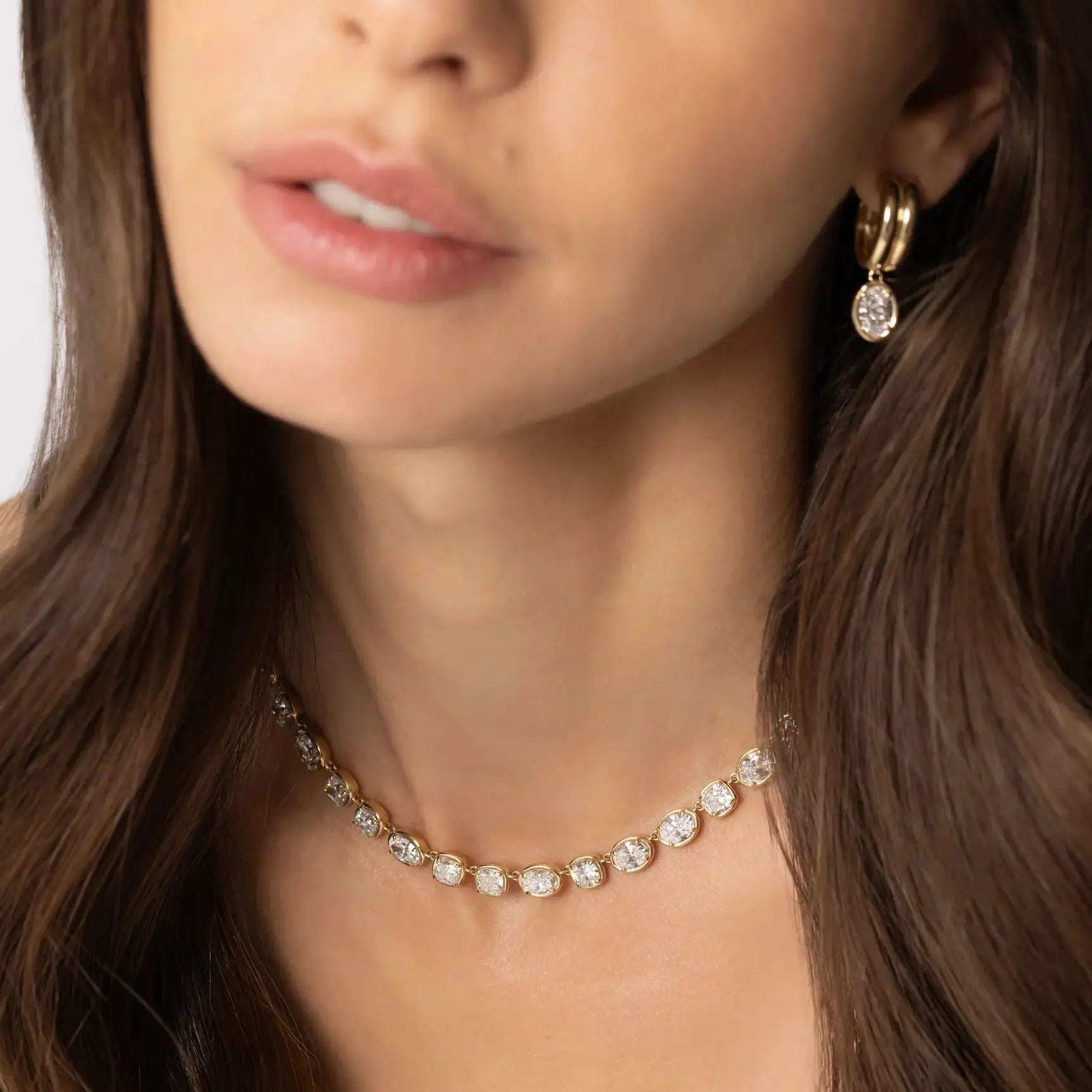Close up of woman waring Odette Oval Drop Earrings and Lisse Tennis Necklace