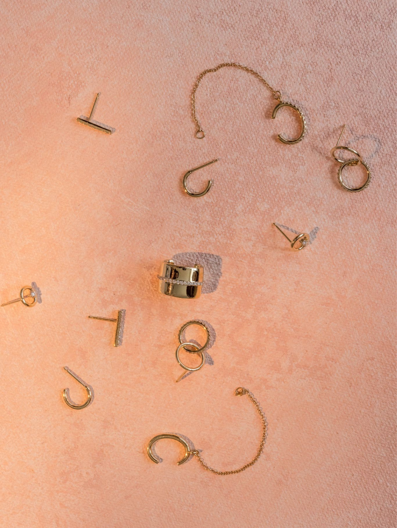 flat lay of Marrow Fine earrings and ear cuffs