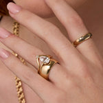 Close up of woman's hand highlighting multiple Marrow Fine diamond rings stacked together