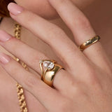 Close up of woman's hand highlighting multiple Marrow Fine diamond rings stacked together