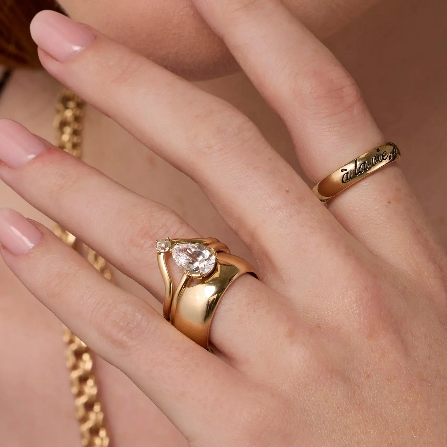 Close up of woman's hand highlighting multiple Marrow Fine diamond rings stacked together