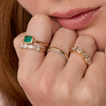 Close up of hand resting against woman's chin featuring multiple styled Marrow Fine rings
