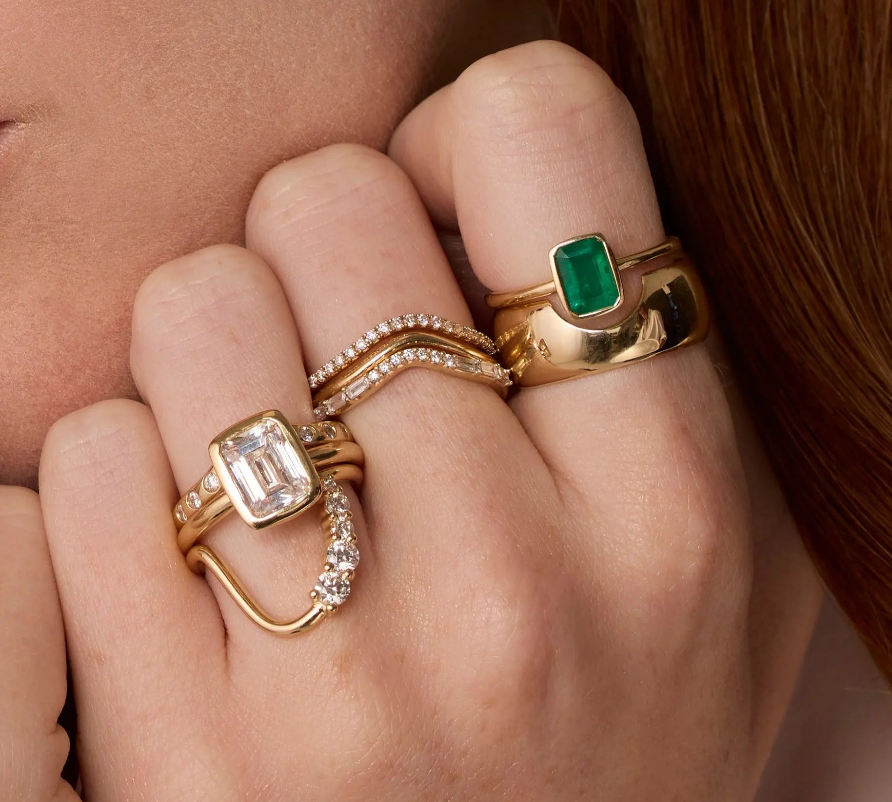 Close up of woman resting hands against chin featuring multiple Marrow Fine rings