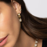 Close up of woman wearing multiple styled Soleil Collection pieces (earrings and necklaces)