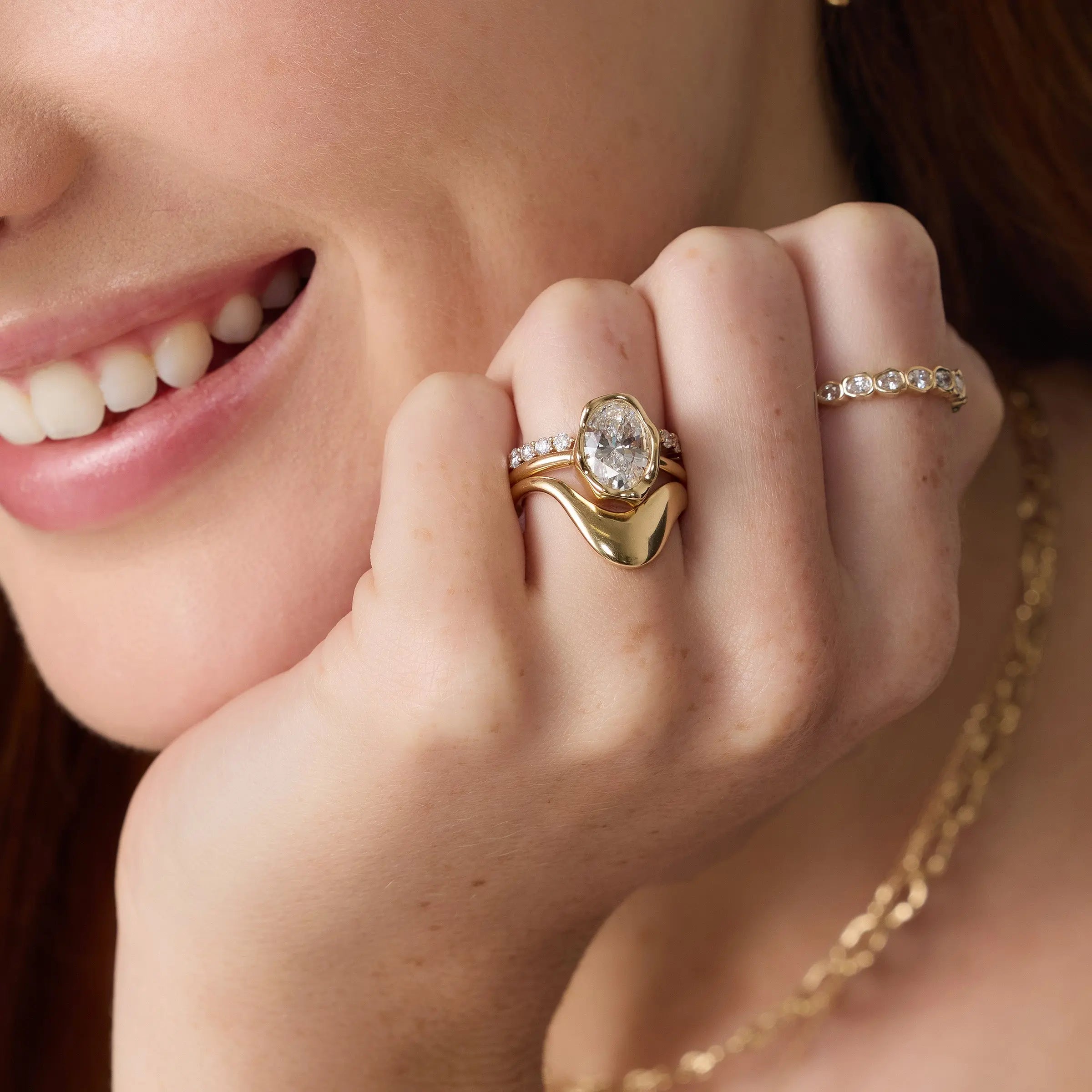 Close up of woman with hands near her face, wearing the Asymmetrical Sculpted Band