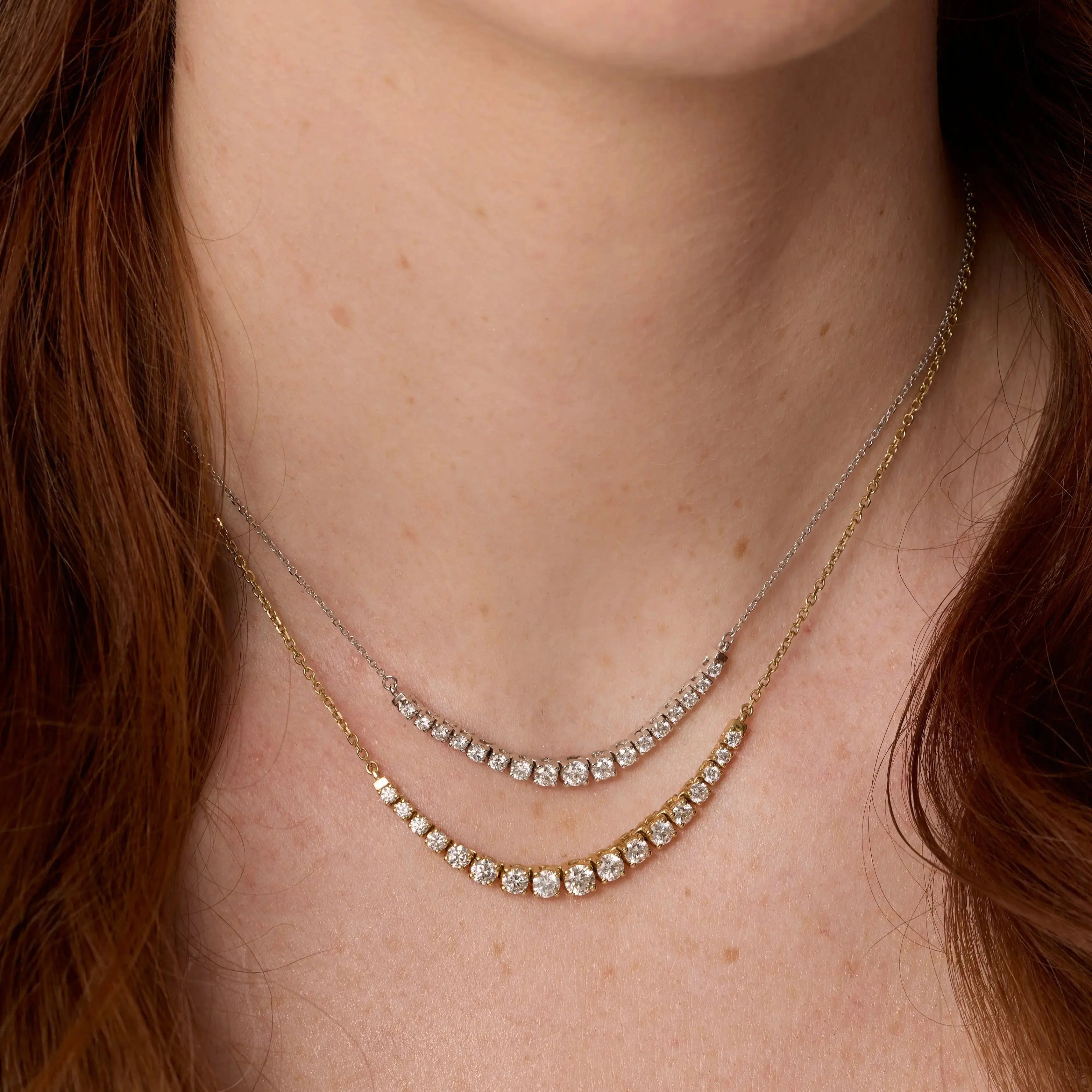 Close up of woman's décolletage spotlighting the Venus White Diamond Graduated Necklace and The Naomi White Diamond Graduated Necklace