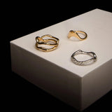 Flat lay of Freeform Gold Ring, Asymmetrical Sculpted Band and White Diamond Pave Ring