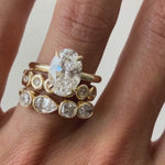 vide of The Francesca Oval Engagement Ring close up on finger, with white background