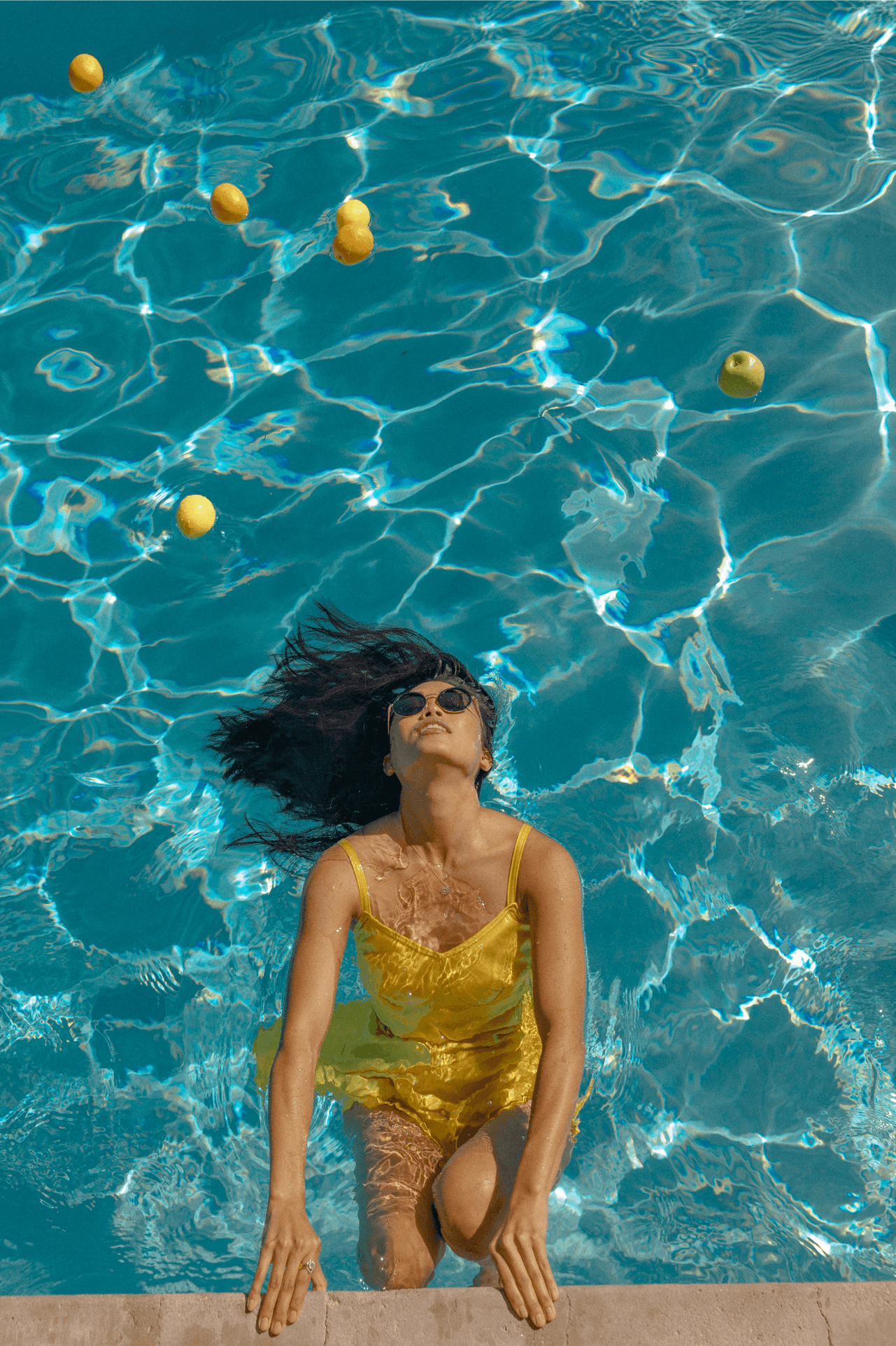 woman swimming in pool dipping head in