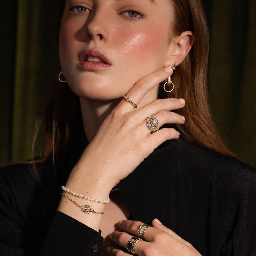 woman looking at camera wearing Marrow fine jewelry