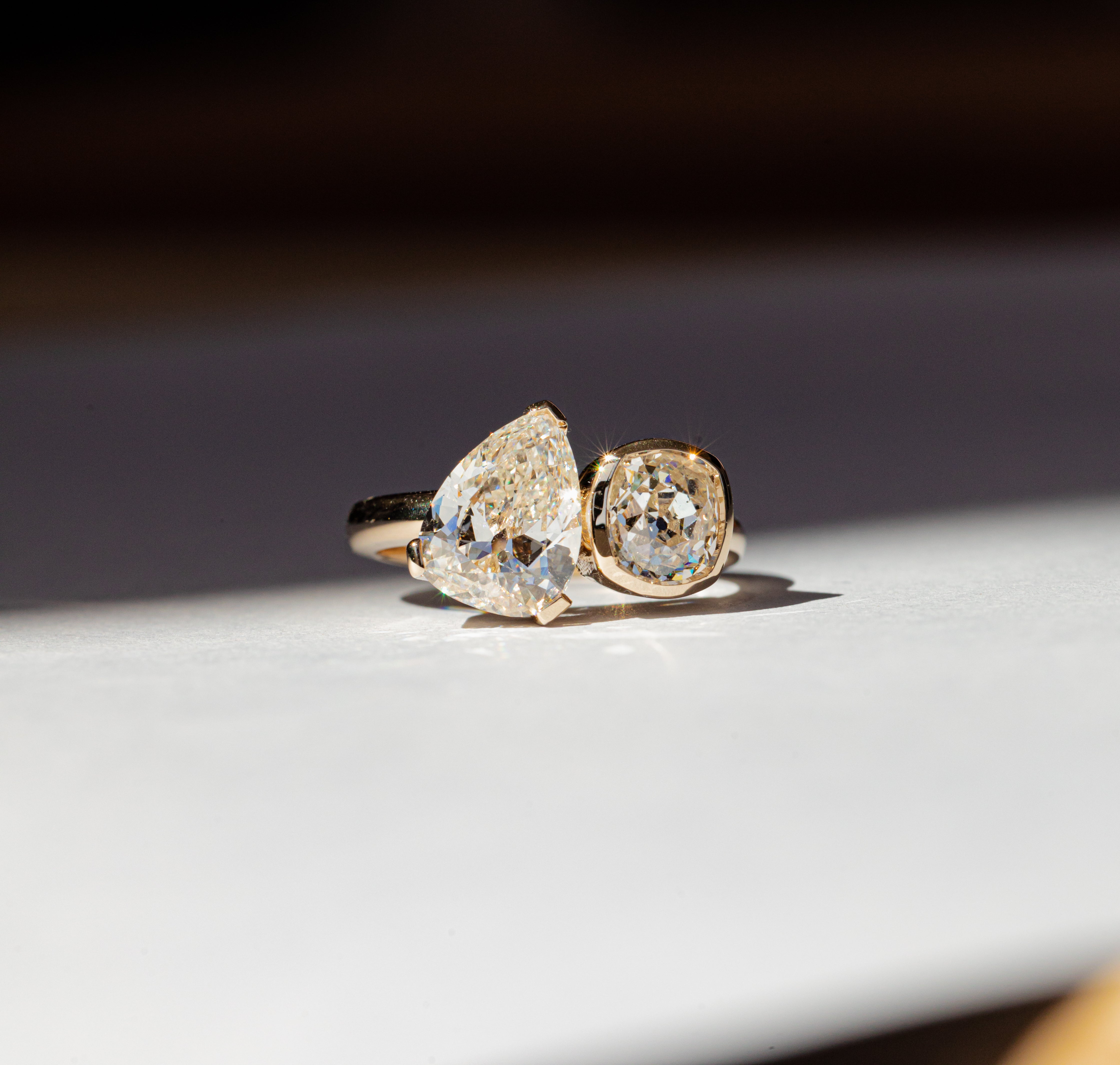 flatlay of white diamond toi et moi ring