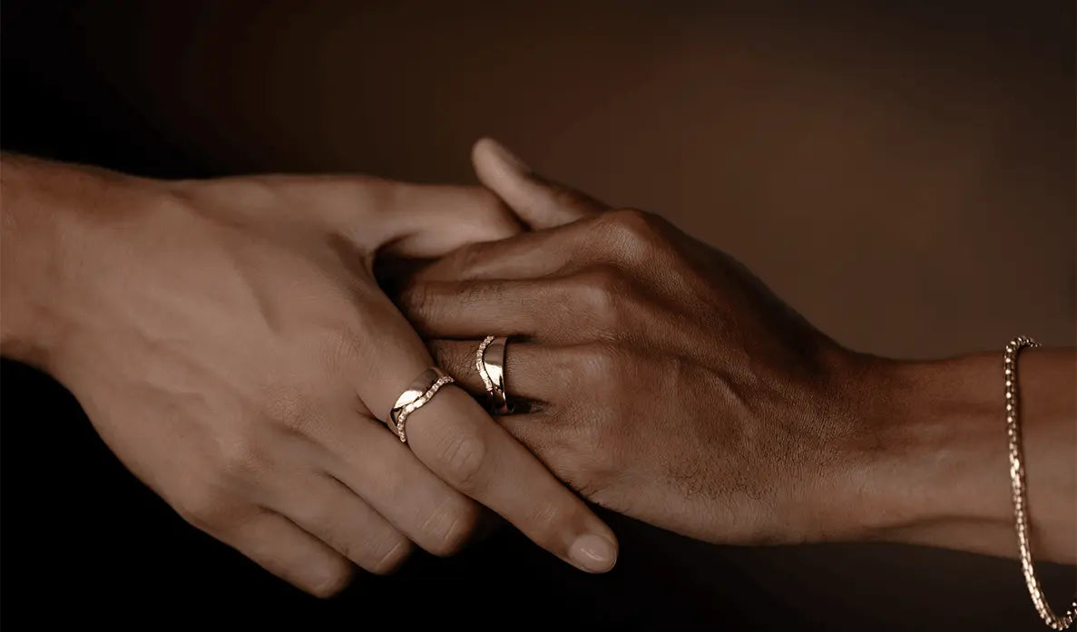 two hands with Marrow rings holding each other