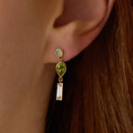 0.35tcw Diamond, 0.94tcw Peridot and Opal Earrings on ear close up