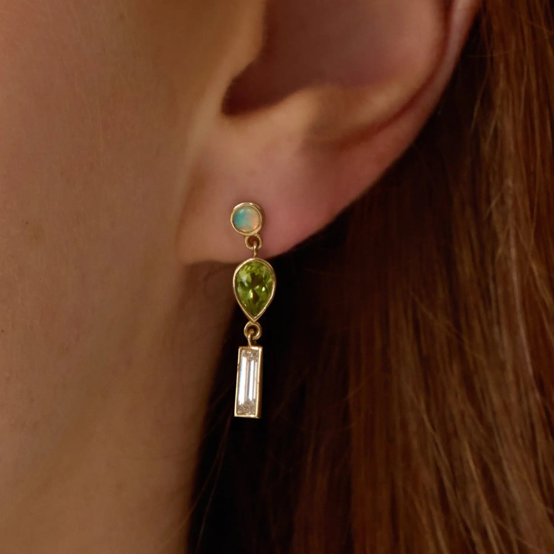0.35tcw Diamond, 0.94tcw Peridot and Opal Earrings on ear close up