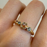 Close up of 0.37ct Montana Sapphire Hexagon Linear Band on woman's hand with neutral background