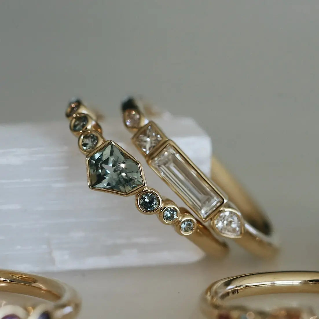Gold ring with gemstones on a white surface