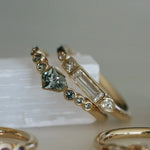 Gold ring with gemstones on a white surface
