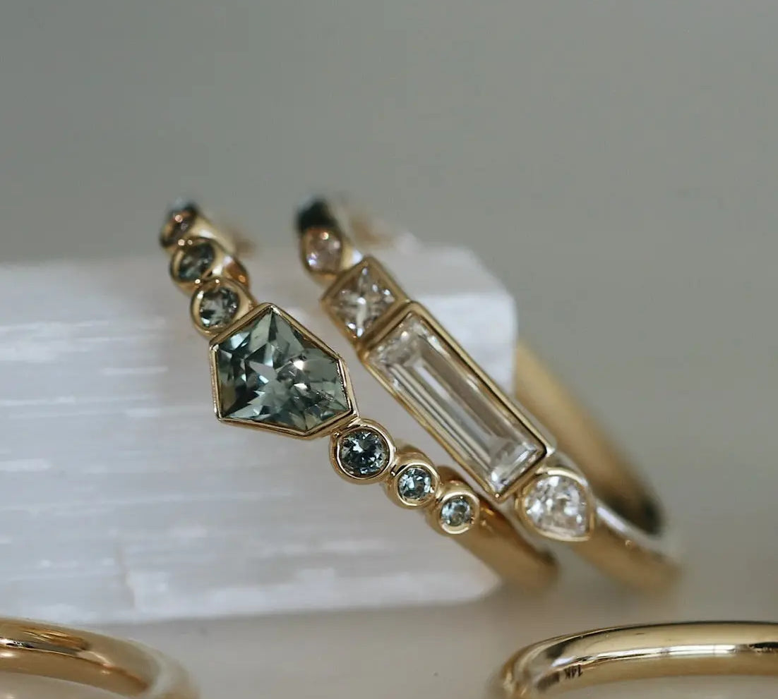 Gold ring with gemstones on a white surface