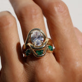 diamond ring with emerald tracer band on hand against a white background