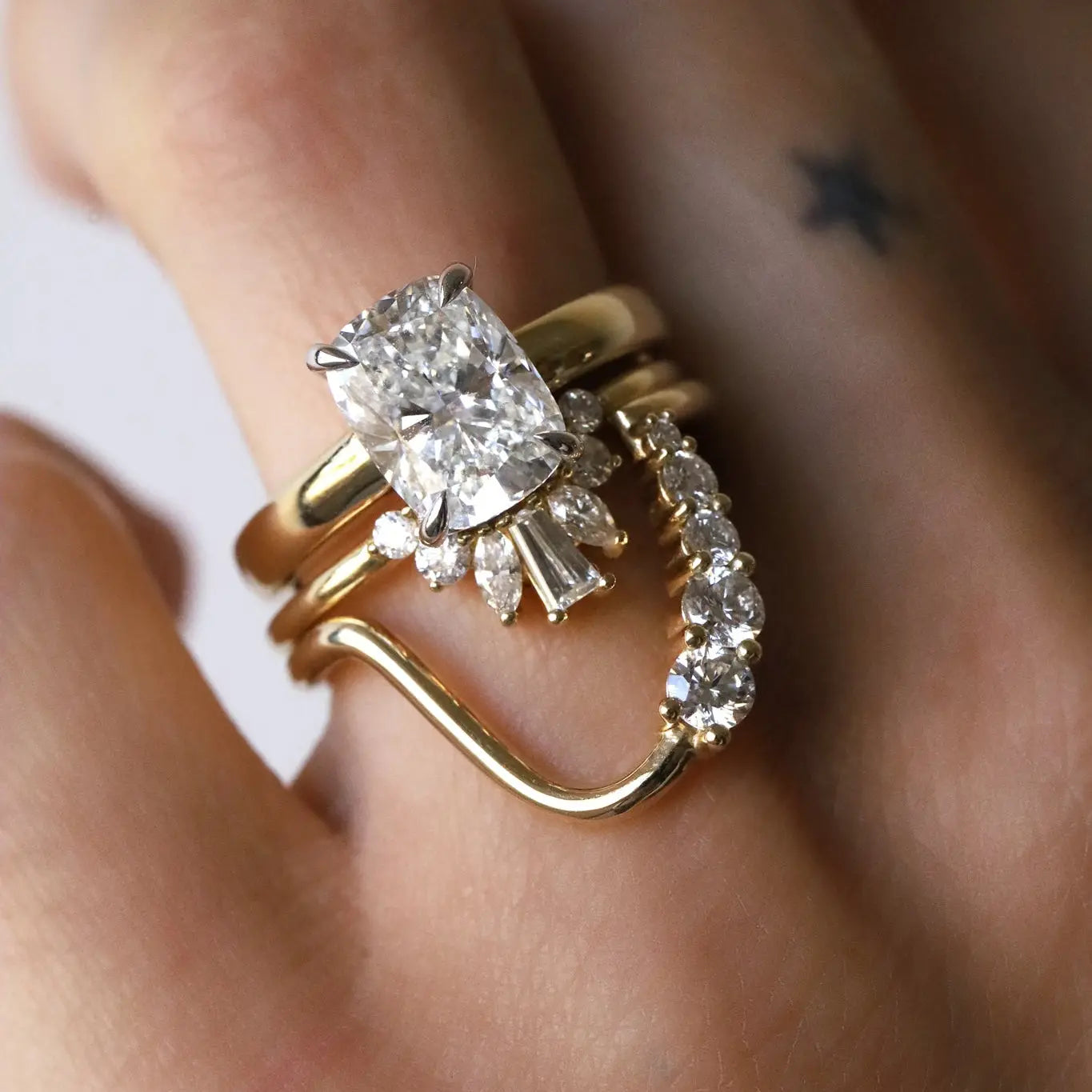 White diamond cushion engagement ring with two stacking bands