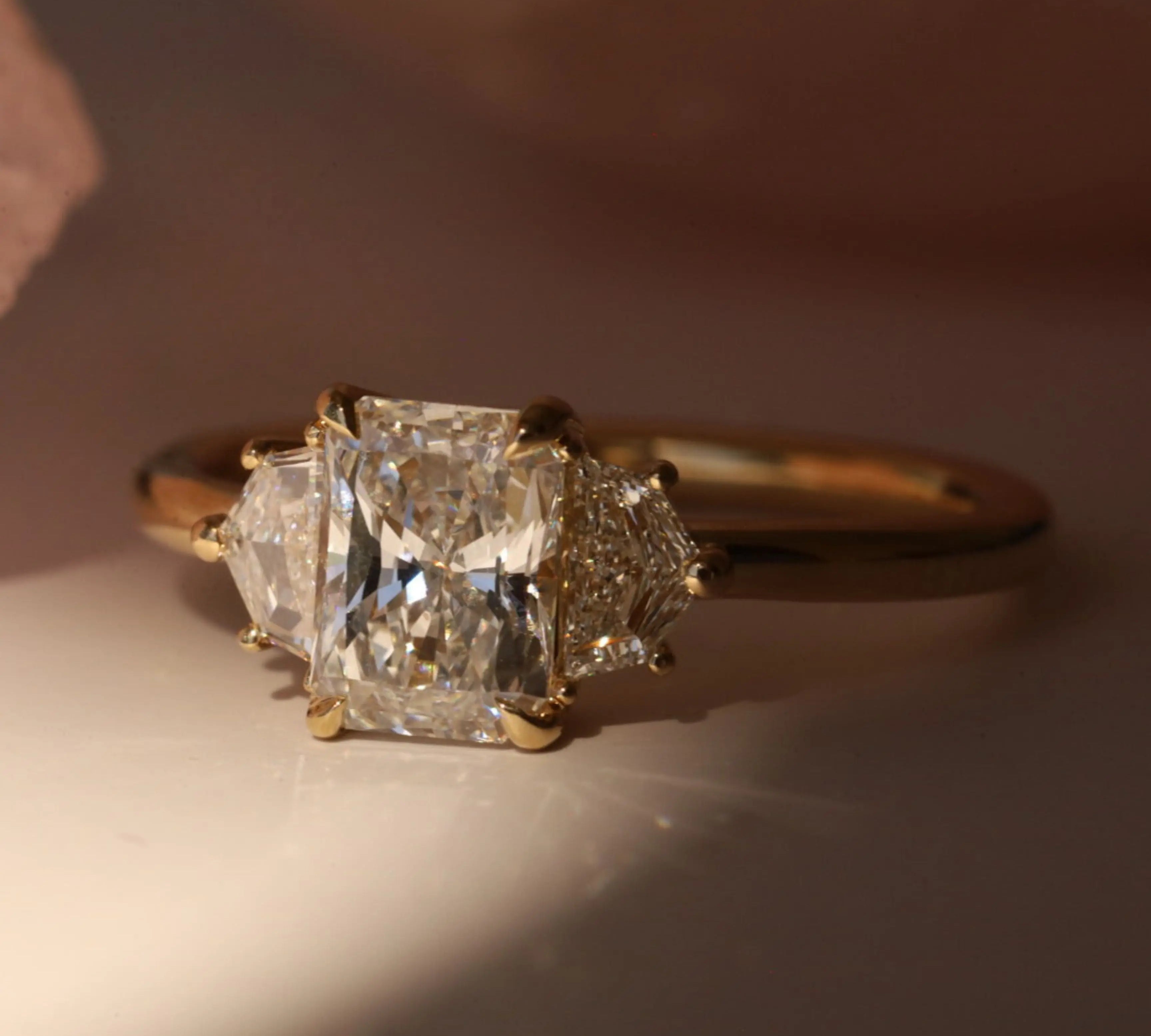 1.09ct Radiant Diamond Band & 0.28tcw Cadillac Diamond Ring [flat lay]