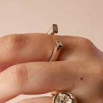 close up of horseshoe ring with baguette diamonds on finger