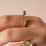 close up of horseshoe ring with baguette diamonds on finger