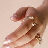 close up of horseshoe ring with baguette diamonds on finger