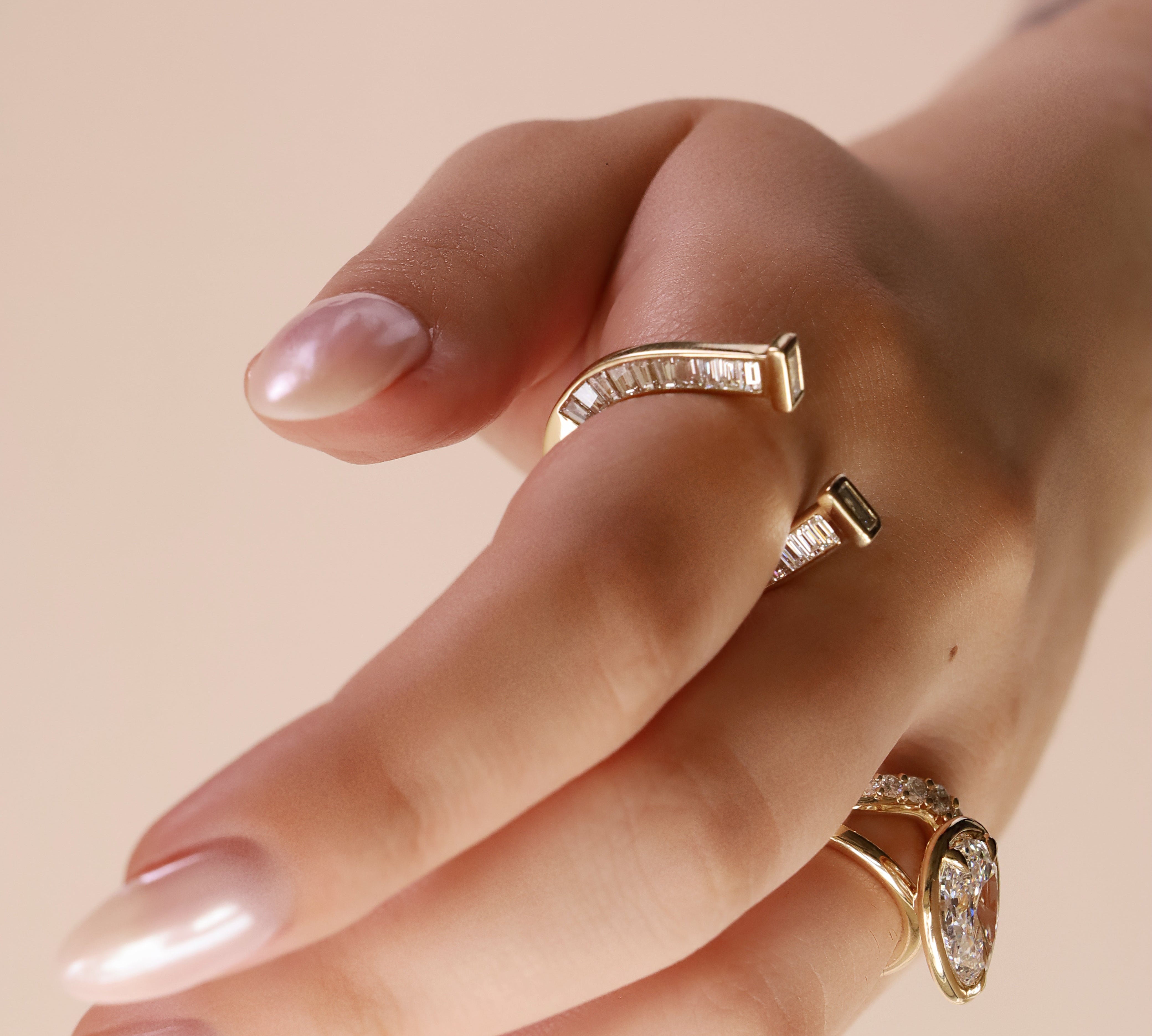 close up of horseshoe ring with baguette diamonds on finger
