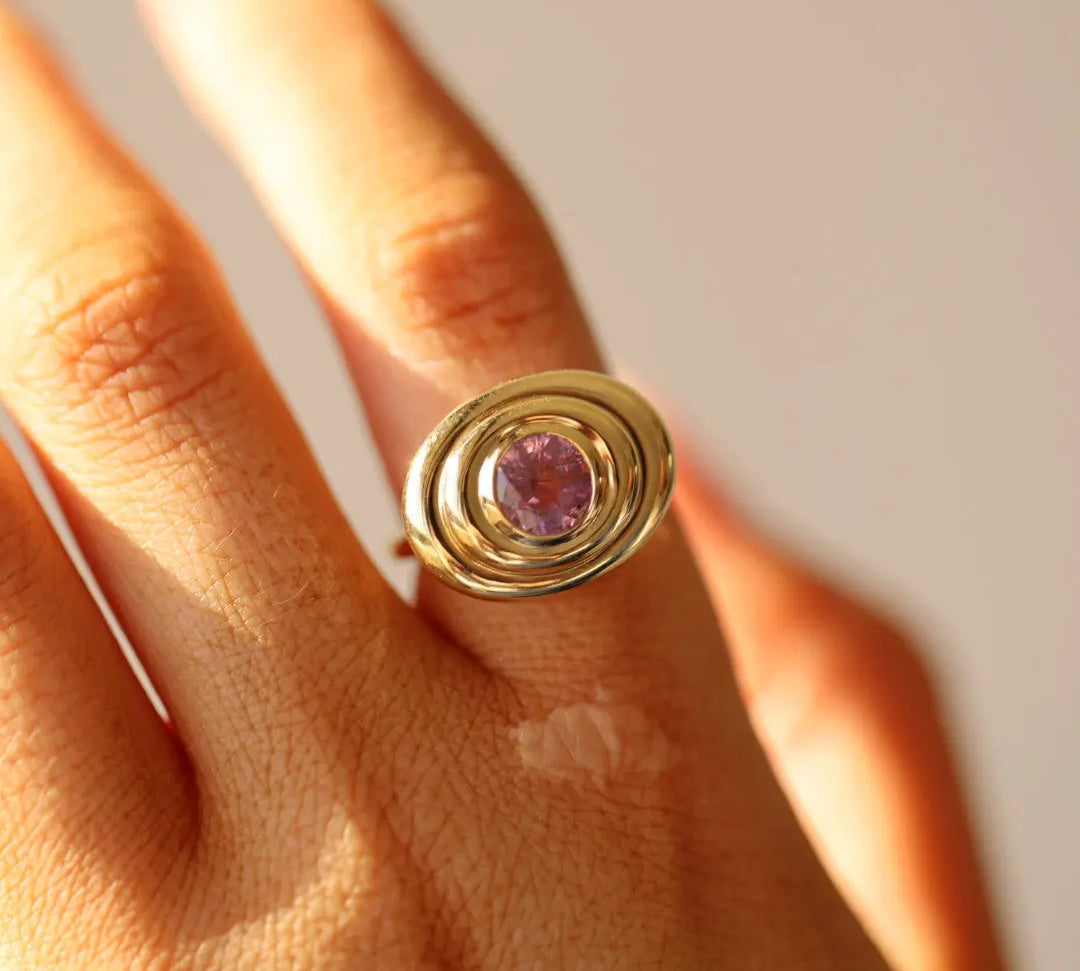 Close up of 1.50ct Pink Sapphire In-Orbit Ring on finger