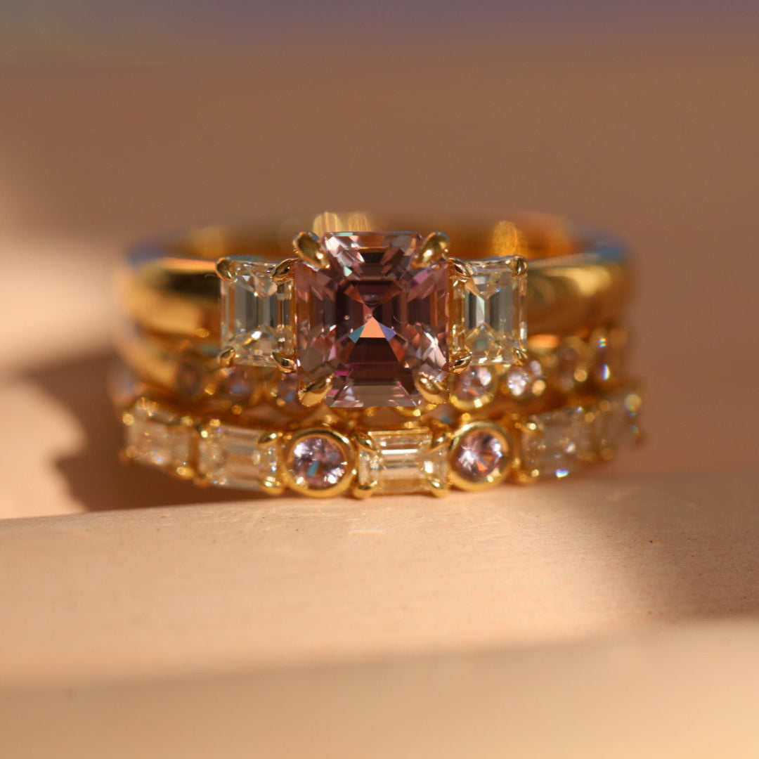 Flat lay of 1.76ct Pink Sapphire and Diamond Ring with Cosmic Light & Third Band