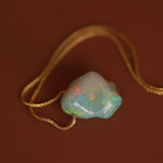opal pendant on dark background