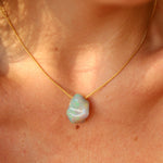 10.41ct Mexian Blue Opal Freeform Necklace on a persons neck