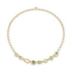 Gold necklace with green and pink gemstones on a white background