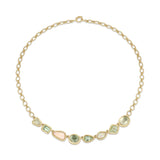 Gold necklace with green and pink gemstones on a white background