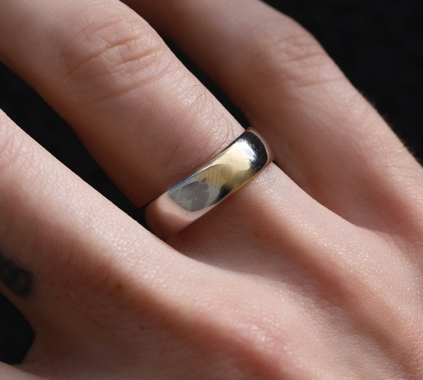 Close up of two-tone men's band on hand