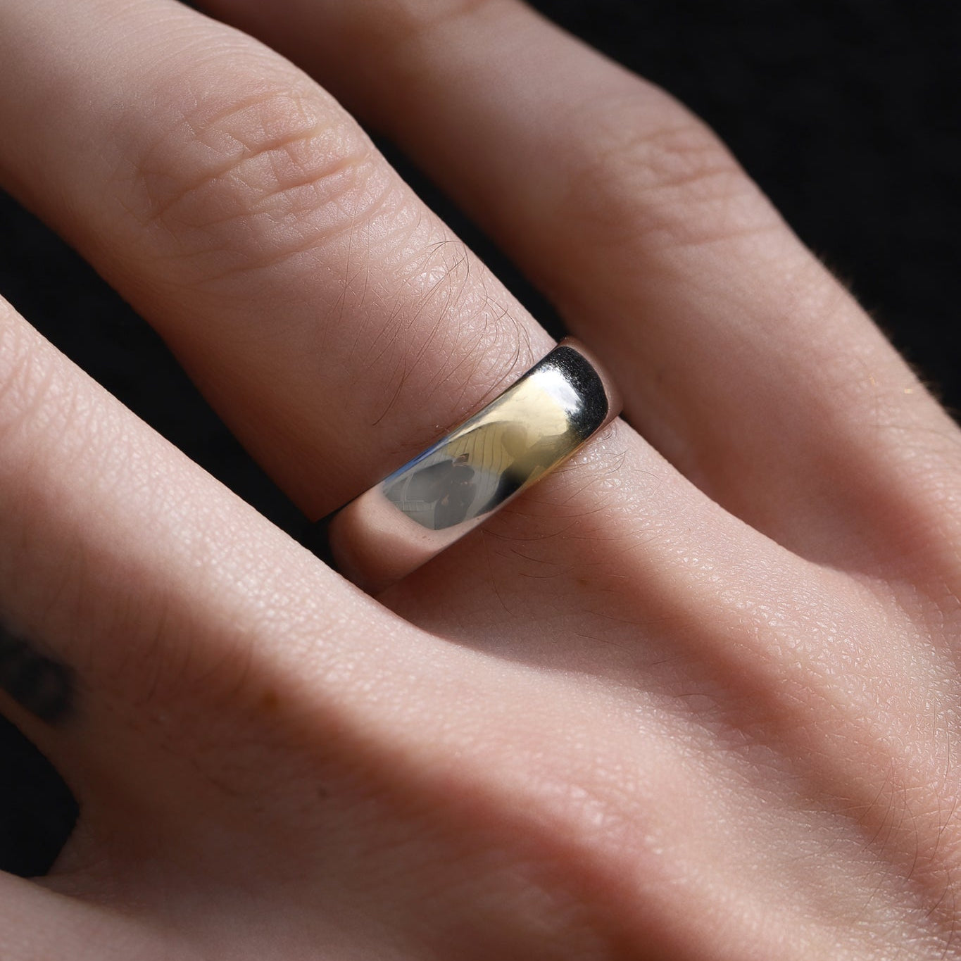 Close up of two-tone men's band on hand