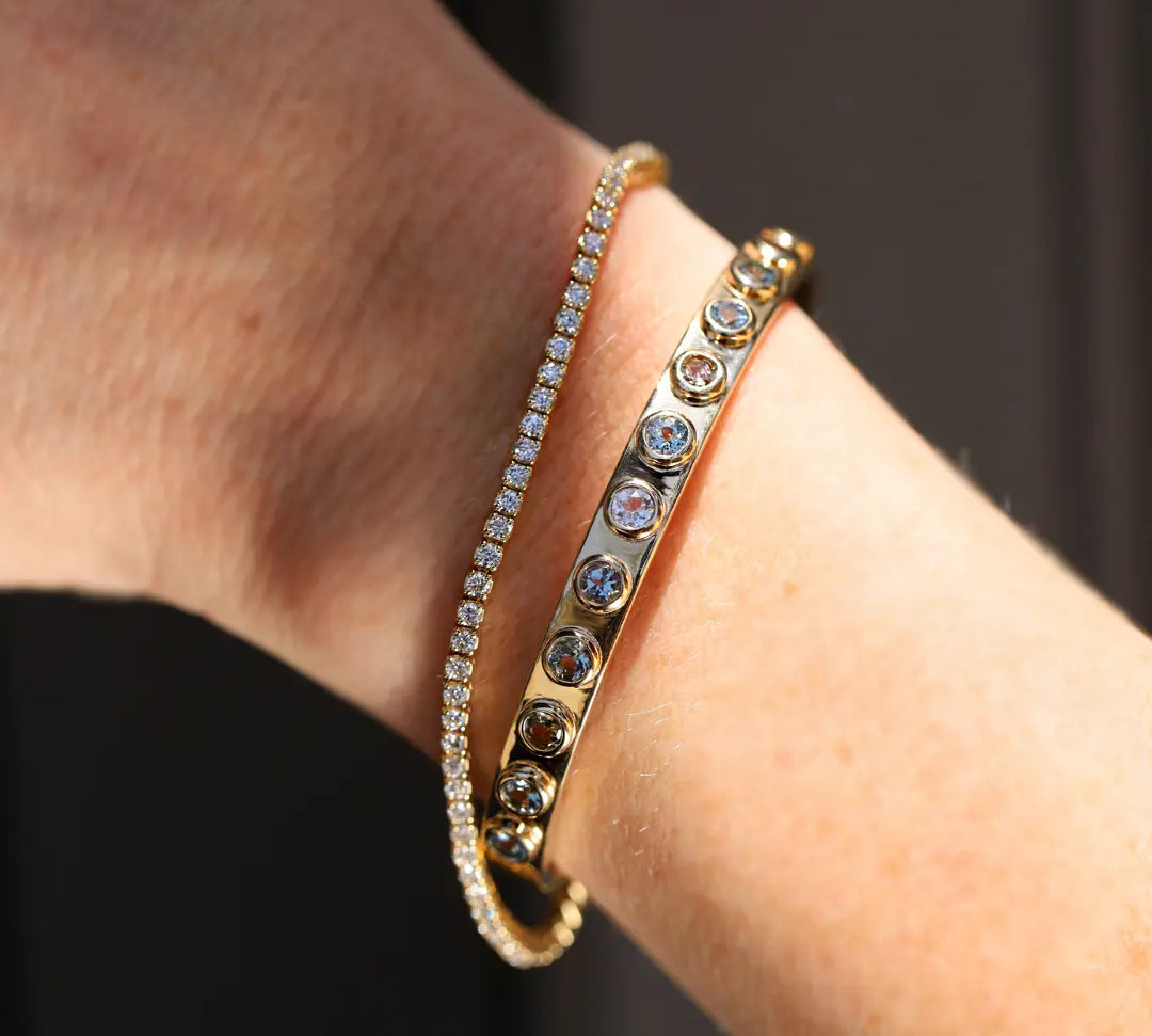 2.02tcw Tanzanite Cuff shot on a person's wrist styled with the White Diamond Maria Tennis Bracelet. 