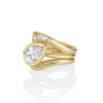 Gold ring with a large pear-shaped diamond and smaller diamonds on a white background
